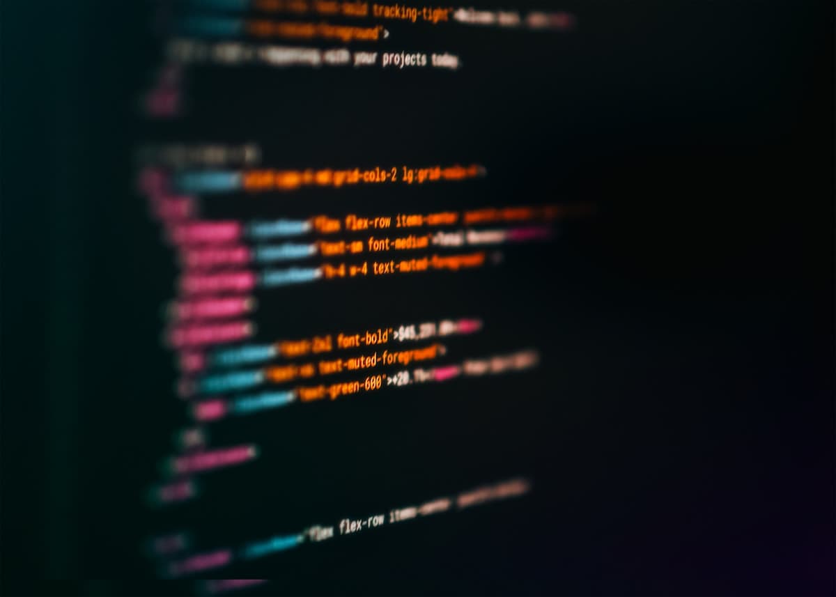 Blurred close-up of syntax-highlighted code on a dark screen